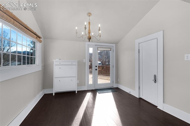 interior space with lofted ceiling, baseboards, dark wood-style flooring, and a chandelier