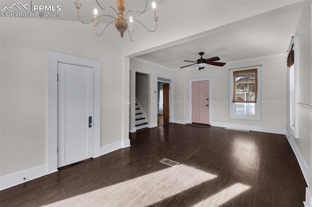 unfurnished living room with stairs, wood finished floors, baseboards, and ornamental molding