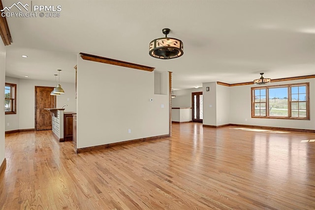 14060 Black Forest Rd, Colorado Springs, CO 80908 - unfurnished living room featuring light wood-style flooring, a ceiling fan, baseboards, and plenty of natural light
