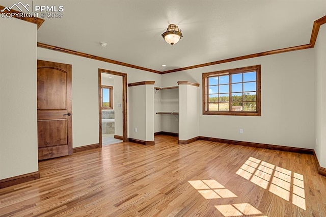 14060 Black Forest Rd, Colorado Springs, CO 80908 - unfurnished bedroom featuring baseboards, light wood-style floors, a closet, crown molding, and ensuite bath