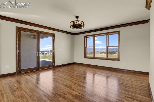 14060 Black Forest Rd, Colorado Springs, CO 80908 - empty room featuring baseboards, ornamental molding, and wood finished floors