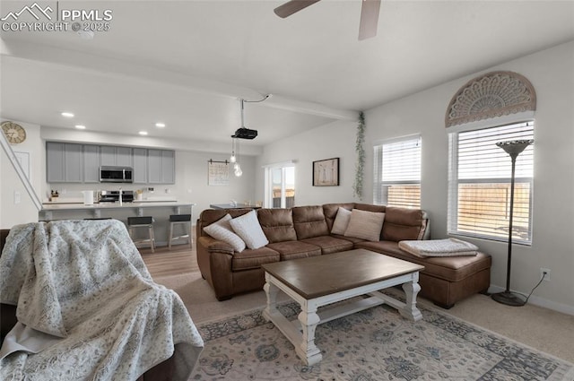 living area featuring a ceiling fan, beamed ceiling, recessed lighting, and baseboards