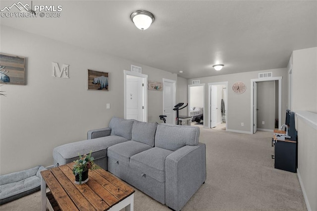 living room featuring light carpet, visible vents, and baseboards