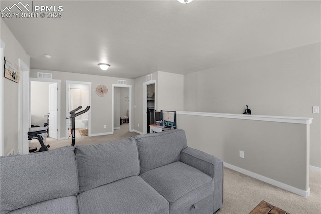 living area with baseboards, visible vents, and light carpet