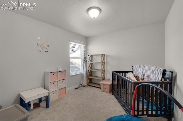 carpeted bedroom with a crib