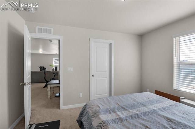 bedroom with visible vents, baseboards, and carpet