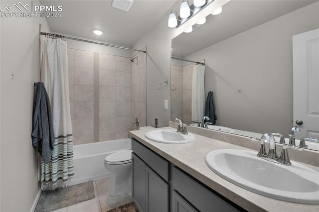 full bath with a sink, visible vents, double vanity, and tile patterned floors