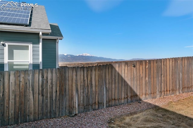 view of yard featuring a mountain view and fence