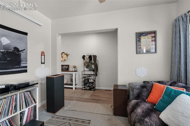 living room with baseboards and wood finished floors