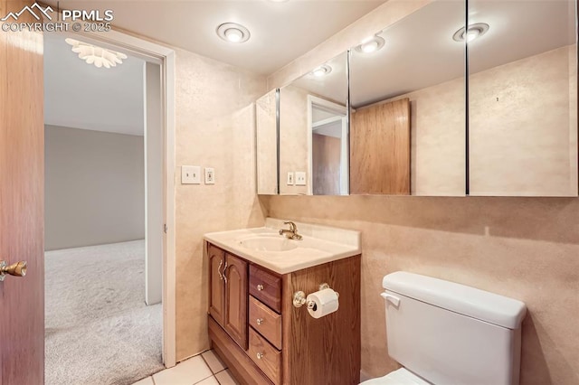 bathroom featuring tile patterned floors, toilet, and vanity