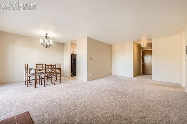 dining room featuring light carpet and a chandelier