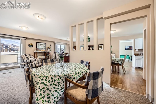 dining area featuring light carpet