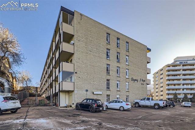 view of building exterior featuring uncovered parking