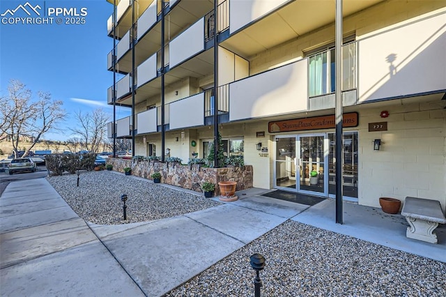 doorway to property featuring concrete block siding