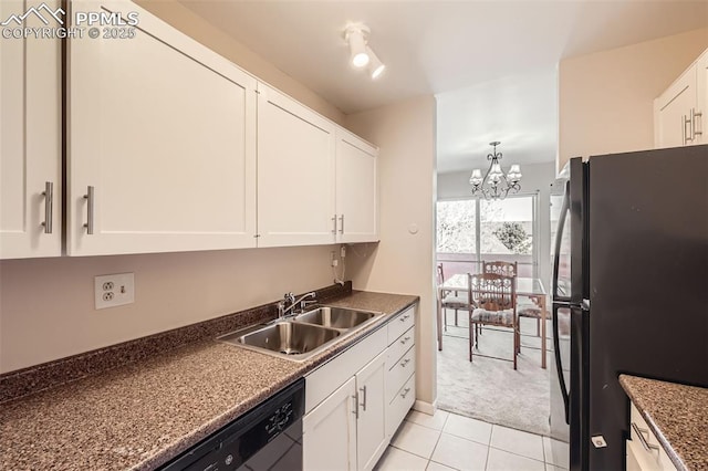 kitchen with white cabinetry, black appliances, dark countertops, and a sink