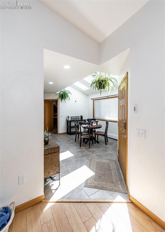 entryway with baseboards and wood finished floors