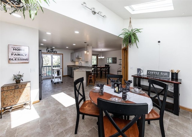 dining room featuring plenty of natural light, recessed lighting, a skylight, and baseboards