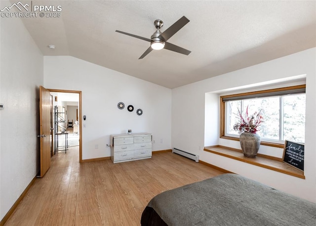 unfurnished bedroom featuring light wood-type flooring, baseboards, baseboard heating, and vaulted ceiling