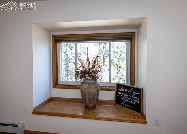 interior details featuring a baseboard heating unit