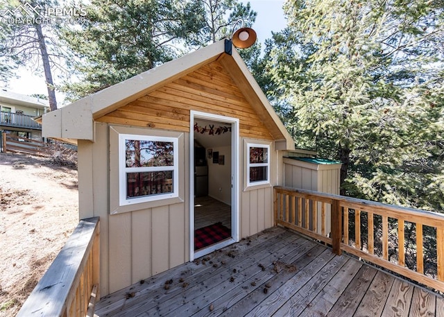 wooden terrace featuring an outbuilding