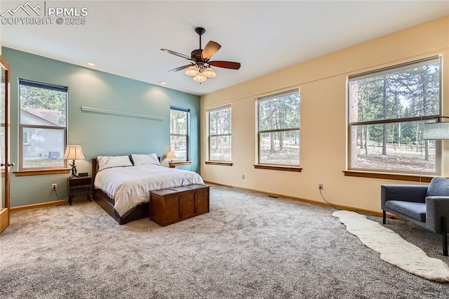 bedroom featuring carpet flooring, multiple windows, and baseboards