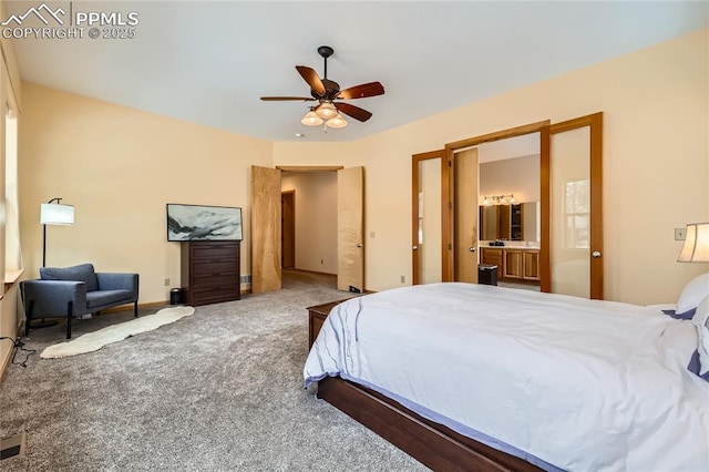 bedroom with carpet flooring, connected bathroom, baseboards, and ceiling fan