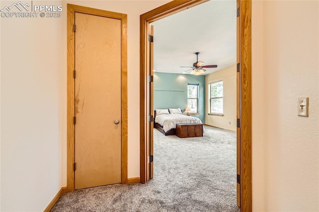 carpeted bedroom featuring baseboards and ceiling fan