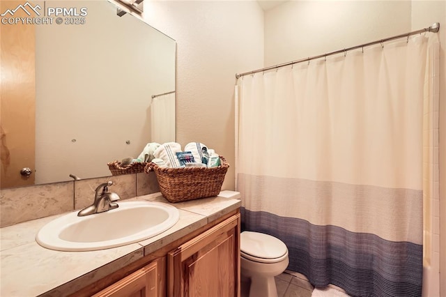 bathroom featuring tile patterned floors, a shower with curtain, toilet, and vanity