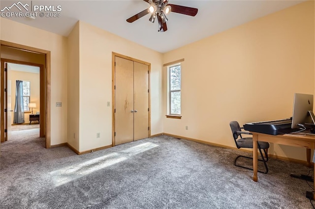 carpeted office featuring baseboards and ceiling fan