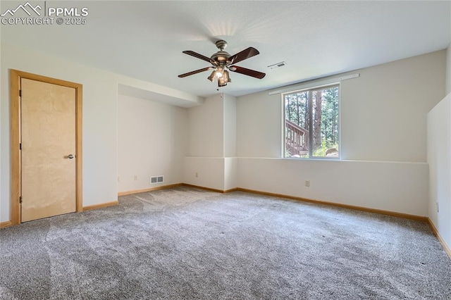 empty room with visible vents, baseboards, ceiling fan, and carpet flooring