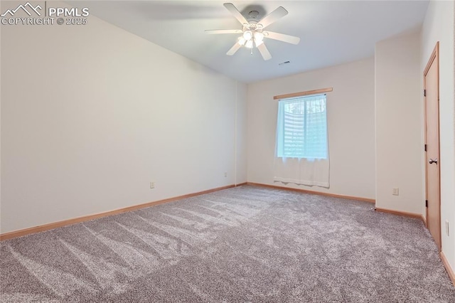 carpeted spare room with visible vents, ceiling fan, and baseboards