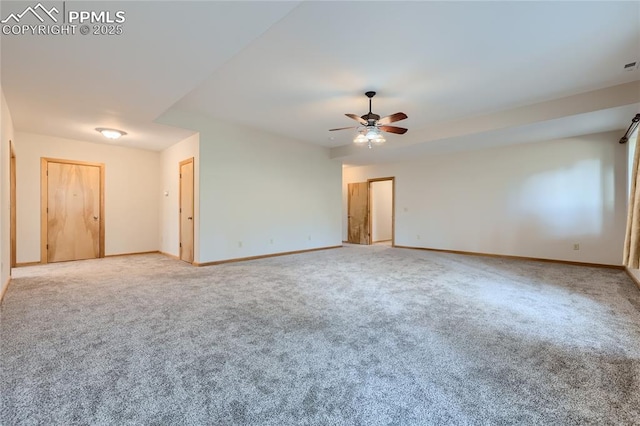 carpeted empty room with a ceiling fan and baseboards