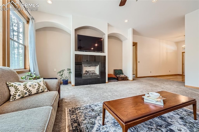 living room with baseboards, carpet flooring, recessed lighting, a fireplace, and a ceiling fan