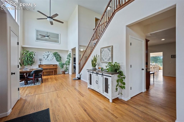 14650 Eastonville Rd, Elbert, CO 80106 - hallway with stairway, baseboards, wood finished floors, and a towering ceiling