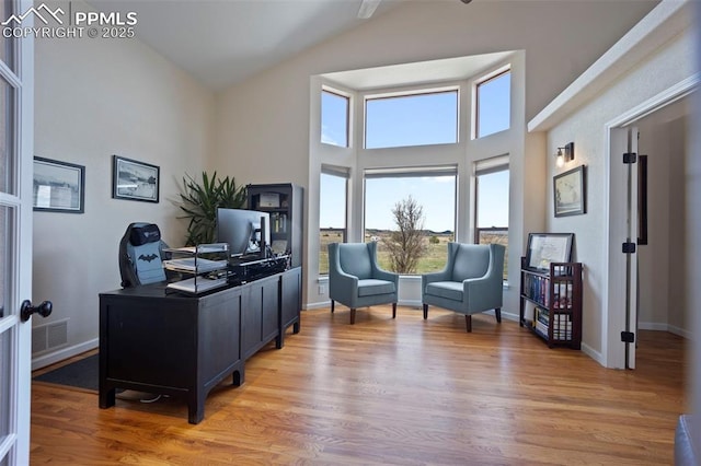 14650 Eastonville Rd, Elbert, CO 80106 - office space with visible vents, baseboards, high vaulted ceiling, and light wood-type flooring