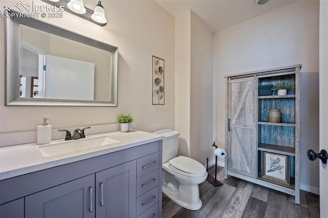 14650 Eastonville Rd, Elbert, CO 80106 - half bathroom featuring toilet, wood finished floors, and vanity
