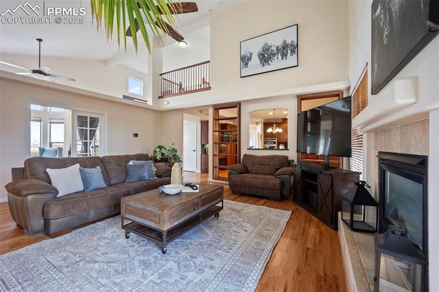 14650 Eastonville Rd, Elbert, CO 80106 - living area featuring a fireplace, beam ceiling, a ceiling fan, and wood finished floors
