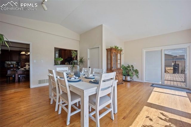 14650 Eastonville Rd, Elbert, CO 80106 - dining area with baseboards, visible vents, lofted ceiling, and light wood-type flooring