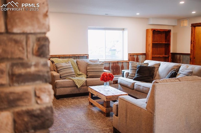 14650 Eastonville Rd, Elbert, CO 80106 - living room with carpet flooring, recessed lighting, wood walls, and a wainscoted wall