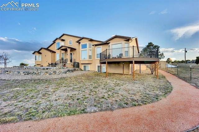 14650 Eastonville Rd, Elbert, CO 80106 - rear view of property featuring fence, stucco siding, central AC, and a deck