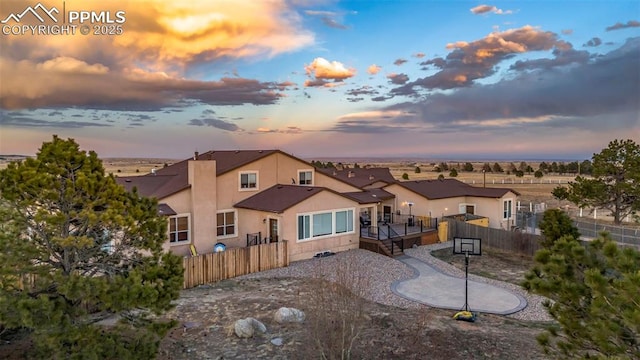 14650 Eastonville Rd, Elbert, CO 80106 - back of house featuring stucco siding, a wooden deck, and fence
