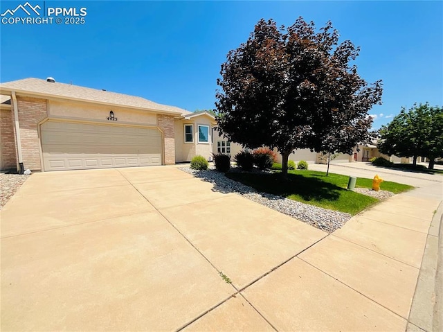 view of front of property featuring brick siding, concrete driveway, and a garage