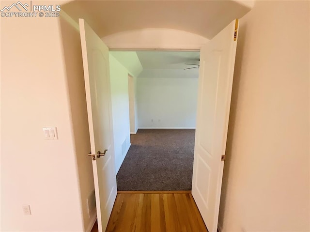 corridor with carpet floors and wood finished floors