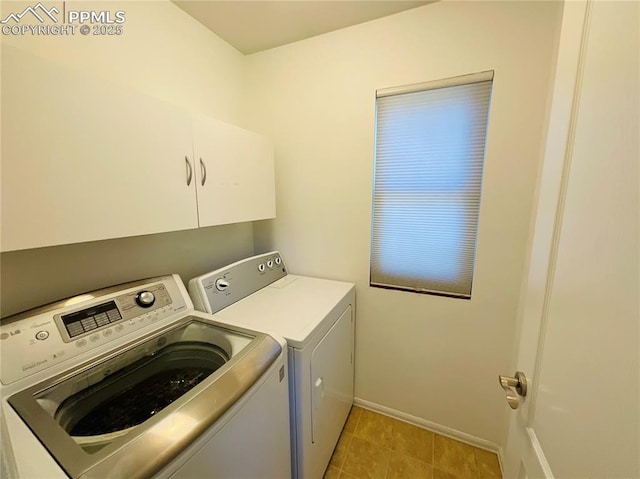 laundry room with cabinet space, baseboards, and washer and clothes dryer