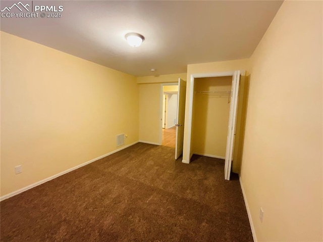 unfurnished bedroom with a closet, baseboards, carpet, and visible vents