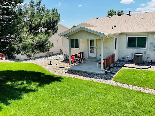 back of property featuring cooling unit, roof with shingles, a yard, stucco siding, and a patio area