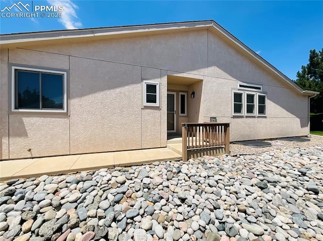 back of house featuring stucco siding