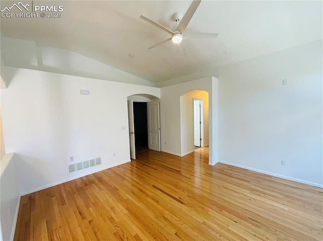 unfurnished room featuring light wood-type flooring, visible vents, a ceiling fan, arched walkways, and lofted ceiling