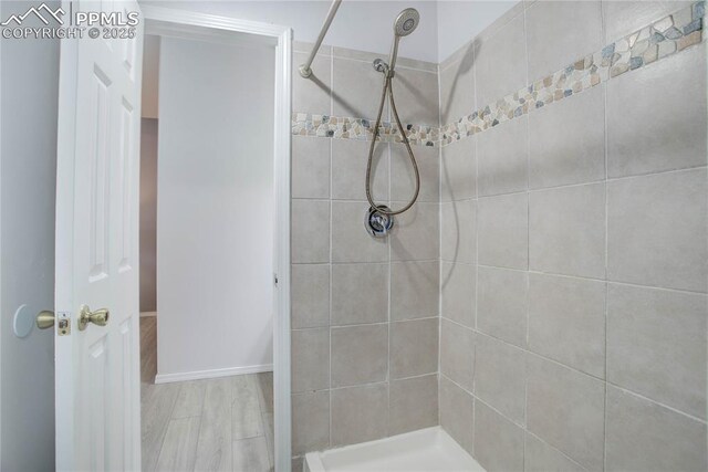 full bath with a tile shower