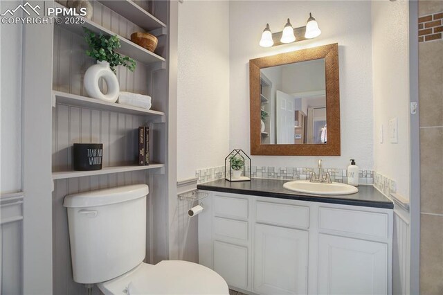 bathroom with toilet and vanity